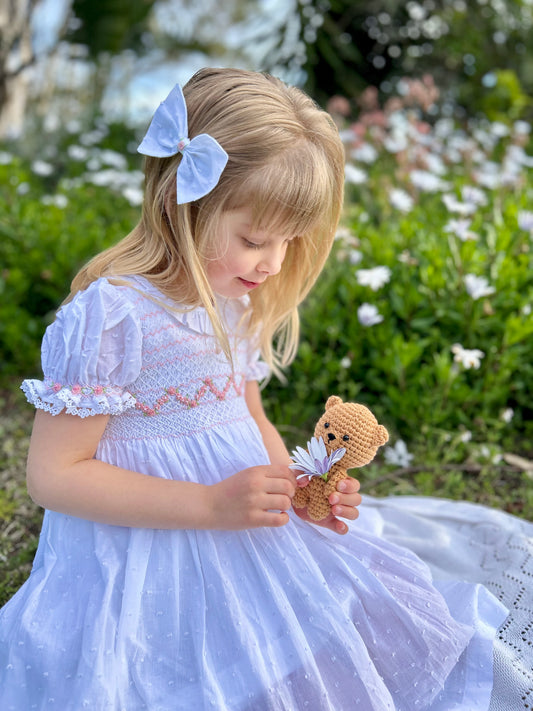 White smocked dress for girls with puff sleeves and pink flower embroidery